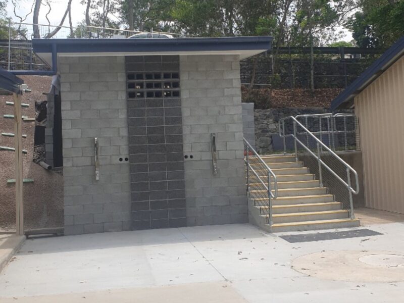Completed blockwork amenities block entry with stainless handrailed stairs and new concrete forecourt.