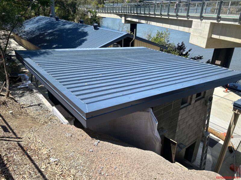 Elevated view of the new amenities block skillion roof with the Brisbane River and Indooroopilly bridge beyond.