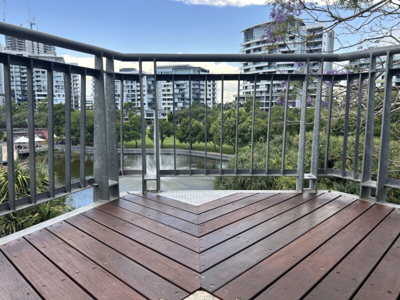 New herringbone-pattern hardwood decking at the lookout bay overlooking the Roma Street Parklands lake, fountain and apartment towers.