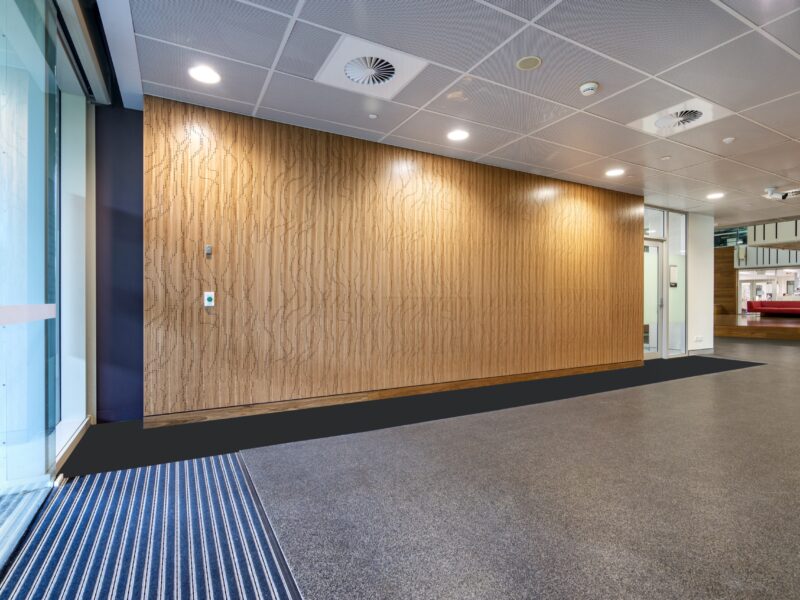 Long perforated timber feature wall along the entry lobby.