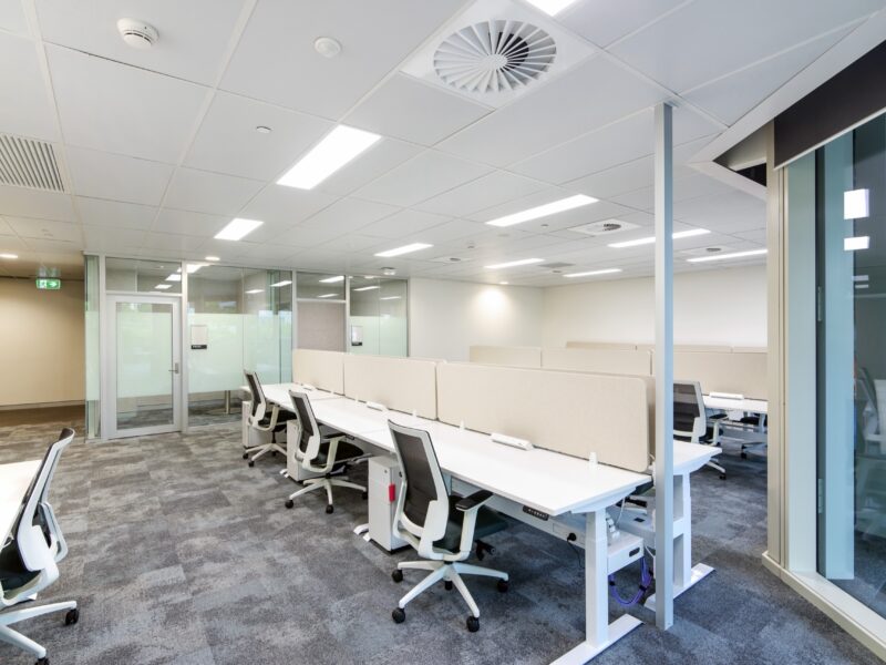 Workstations alongside glazed partitions and new ceiling with swirl diffusers.