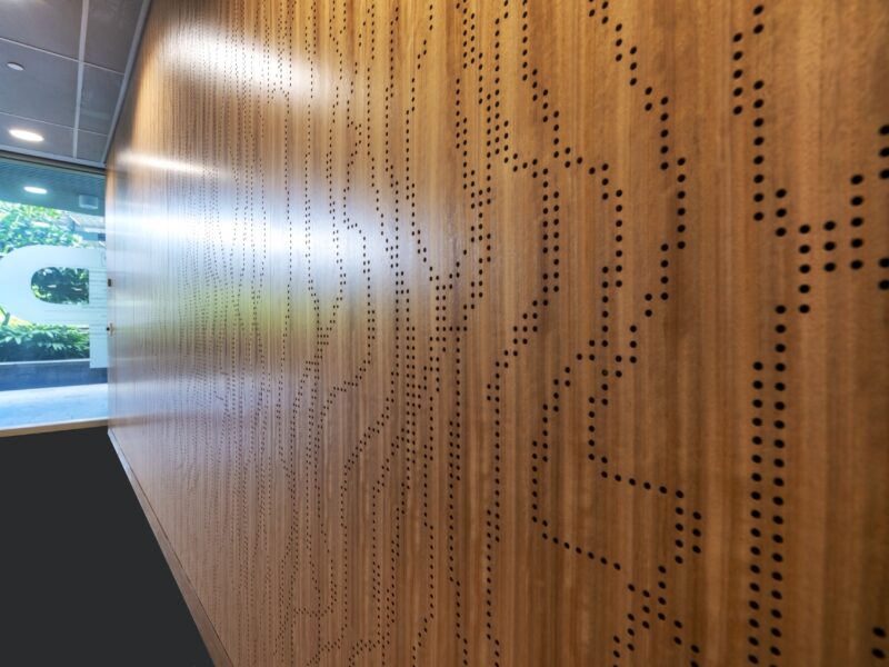 Close-up of the perforated timber feature wall pattern.