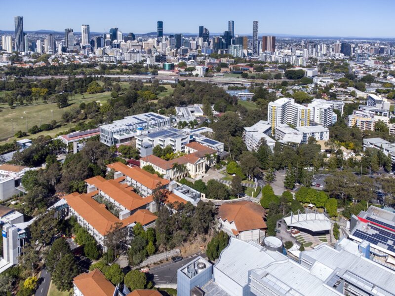 Aerial drone view over QUT Kelvin Grove campus with the Brisbane CBD skyline in the background.