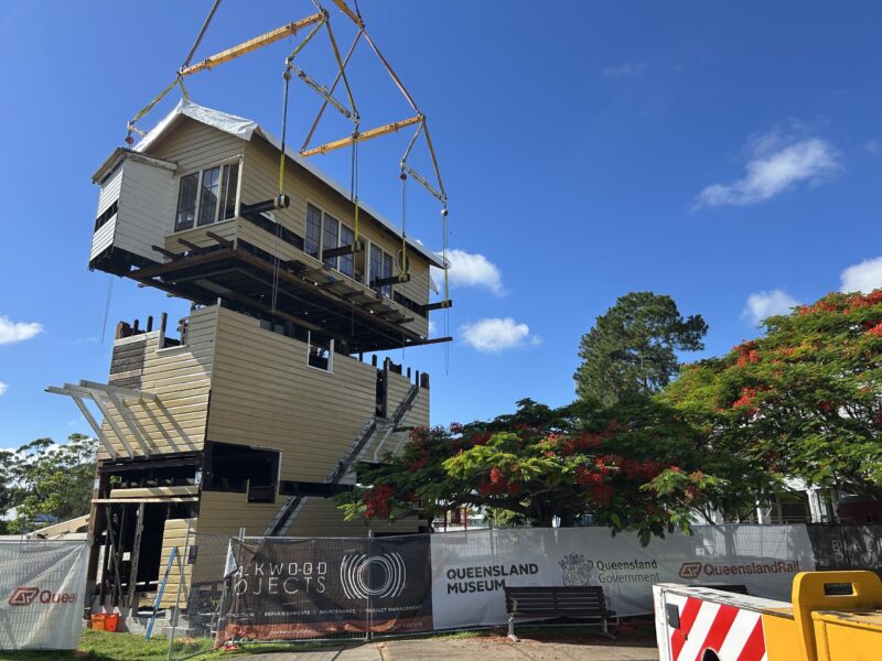 The restored operating room being lowered onto the rebuilt tower.