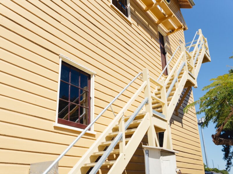 Restored chamferboard cladding, window and external timber stair.