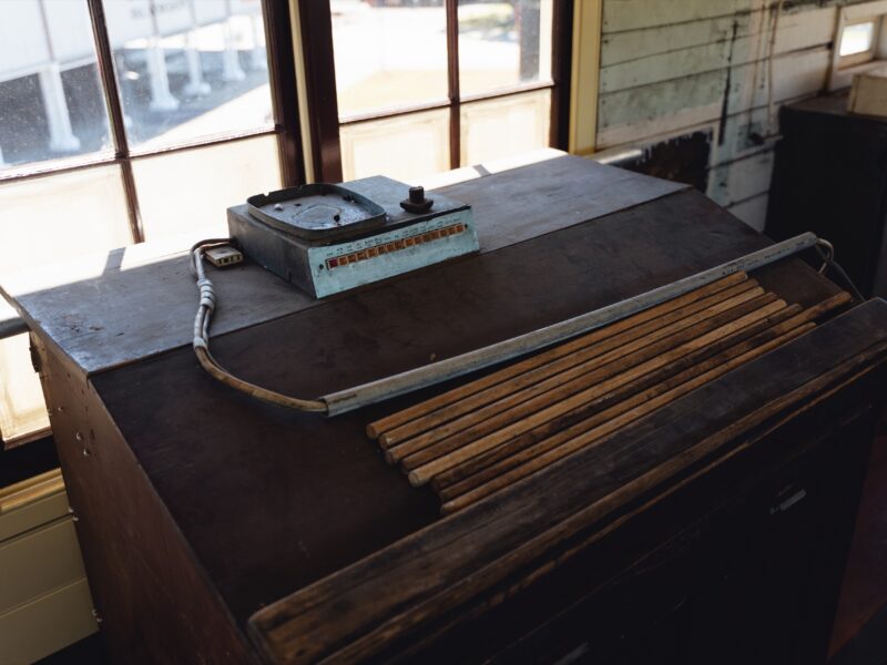Historic signalling instruments on a timber desk in the operating room.