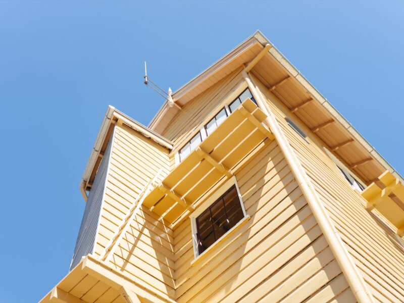 The restored gable, window hood and finial against the sky.